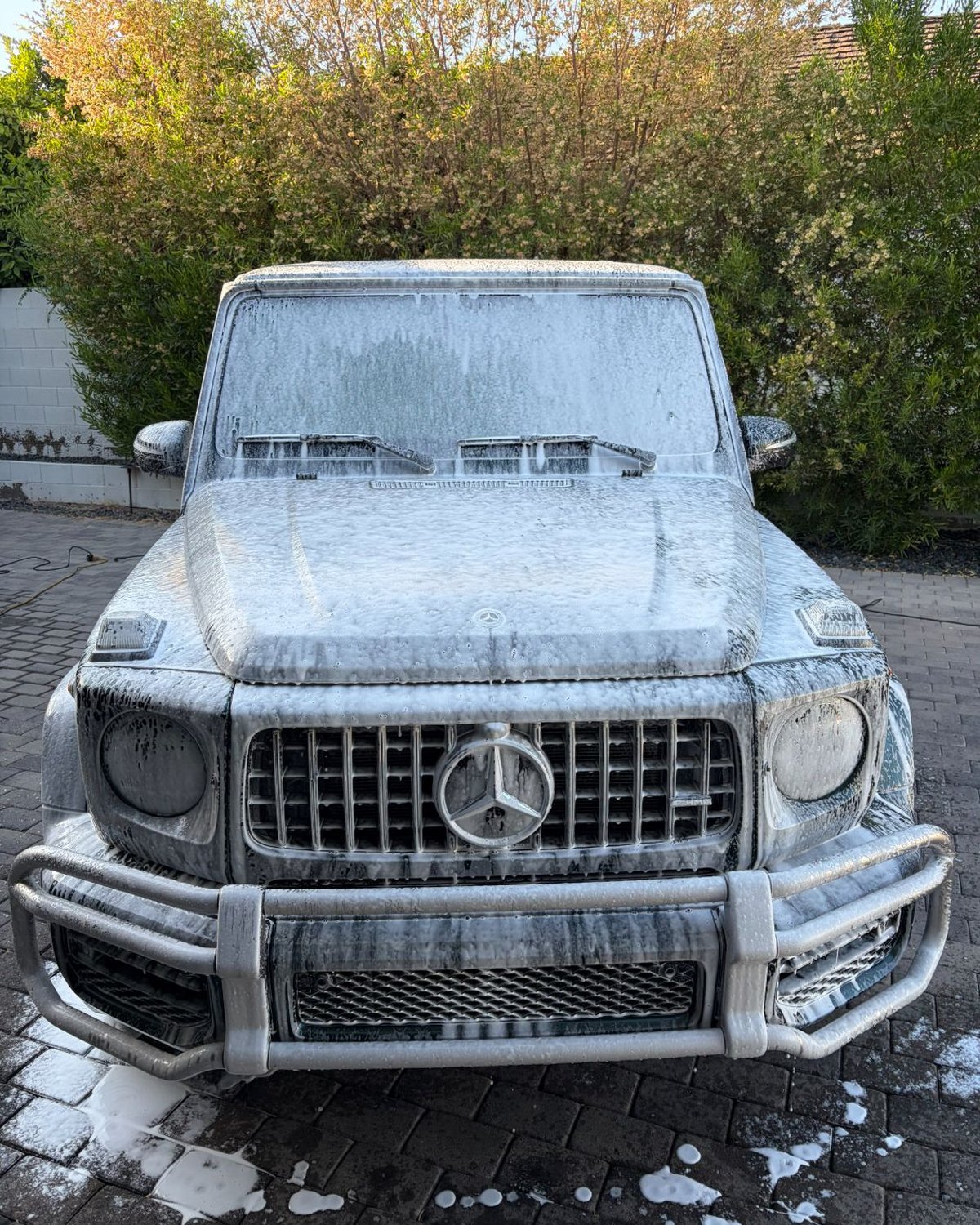 Mercedes G-Wagon mid-wash, covered in foam soap